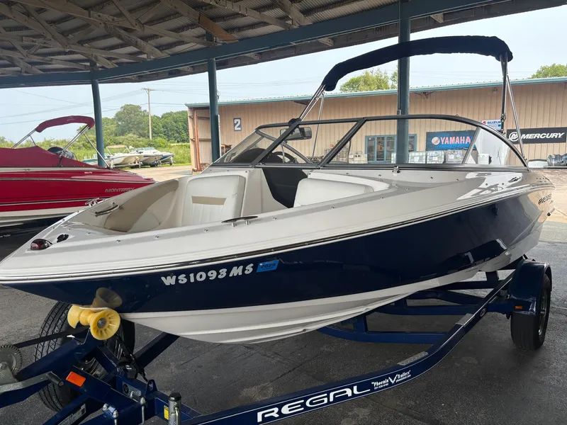 Slide: The Image of A white 2017 Regal 1900 ES Bowrider sits on a blue trailer in a covered area. - 3
