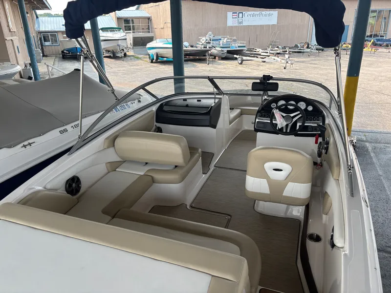 Slide: The Image of The image shows the cockpit of a 2017 Regal 1900 ES Bowrider with beige seating. - 9