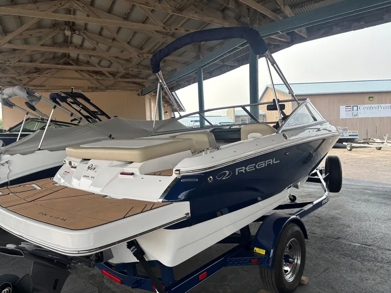 Slide: The Image of A 2017 Regal 1900 ES Bowrider on a trailer in a covered storage area. - 7