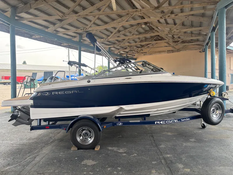 The Image of A 2017 Regal 1900 ES Bowrider on a trailer in a covered storage area. - 0