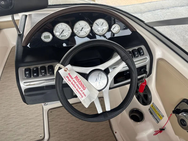 Slide: The Image of The image shows the helm of a 2017 Regal 1900 ES Bowrider with multiple gauges. - 11