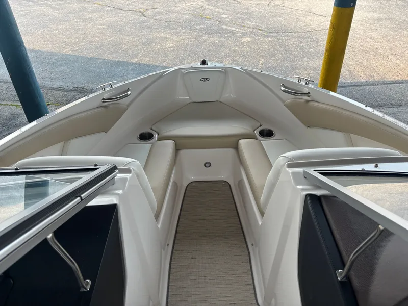 Slide: The Image of The 2017 Regal 1900 ES Bowrider features an open bow area with beige seating and cup holders. - 13