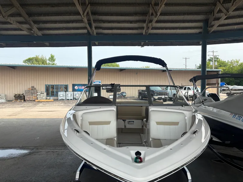 Slide: The Image of 2017 Regal 1900 ES Bowrider parked under a covered area. - 2