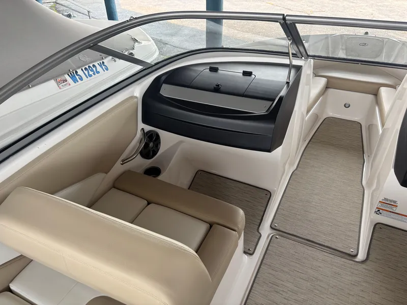Slide: The Image of The image shows the cockpit of a 2017 Regal 1900 ES Bowrider with beige seating. - 12