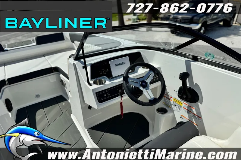 Slide: The Image of 2026 Bayliner D22 boat interior with steering wheel and controls, featuring Simrad display. - 12