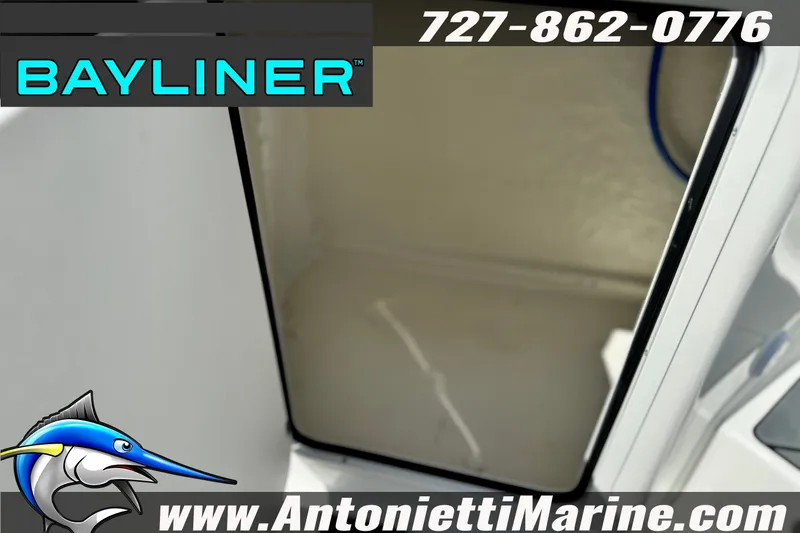 Slide: The Image of 2026 Bayliner D22 boat interior with storage compartment, featuring contact details and logo. - 30