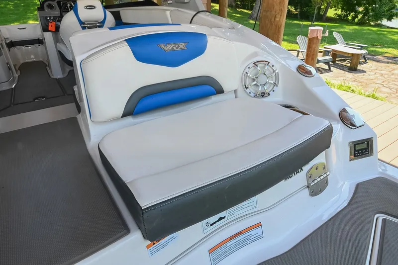 Slide: The Image of 2019 Chaparral Vortex 2430 VRX boat interior with cushioned seating and speaker. - 17