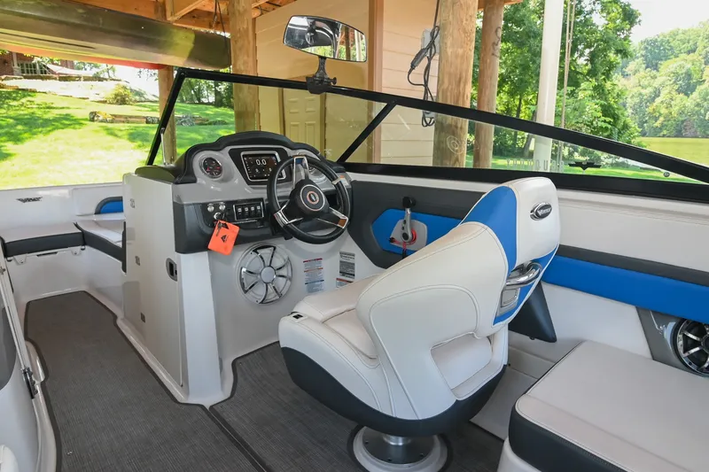 Slide: The Image of 2019 Chaparral Vortex 2430 VRX boat interior with steering wheel and seating. - 36