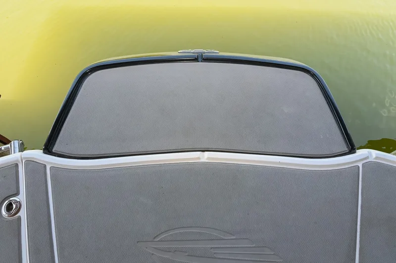 Slide: The Image of 2019 Chaparral Vortex 2430 VRX boat deck, close-up view on calm water. - 14