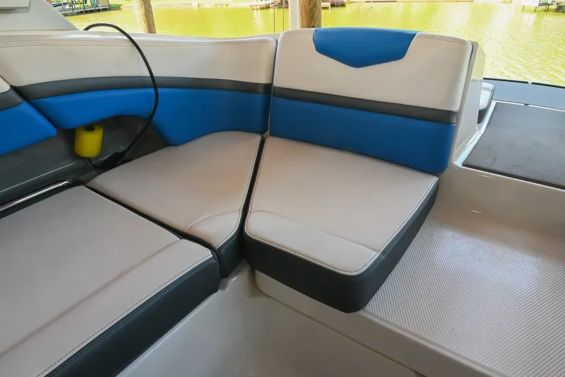 Slide: The Image of 2019 Chaparral Vortex 2430 VRX boat interior with blue and gray seating. - 24