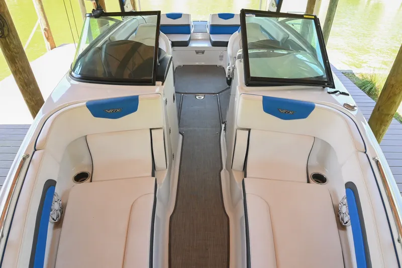 Slide: The Image of 2019 Chaparral Vortex 2430 VRX boat interior with white seating and blue accents. - 47