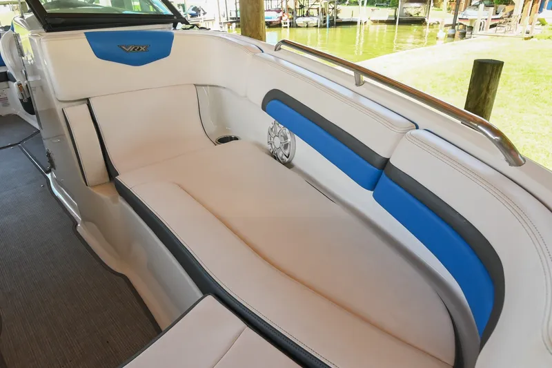 Slide: The Image of 2019 Chaparral Vortex 2430 VRX boat interior with white and blue seating. - 45
