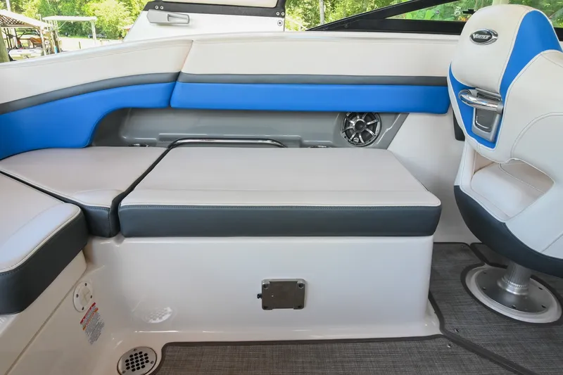 Slide: The Image of 2019 Chaparral Vortex 2430 VRX interior seating with blue accents and speaker detail. - 26