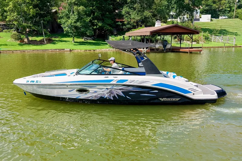 Slide: The Image of 2019 Chaparral 203 Vortex boat cruising on a scenic lake. - 2