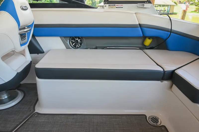 Slide: The Image of 2019 Chaparral Vortex 2430 VRX interior with blue and white seating and speaker. - 23