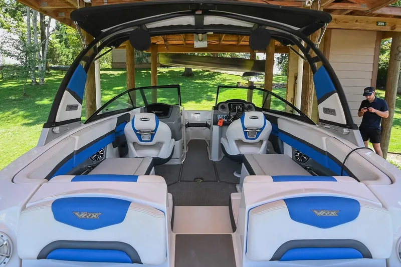 Slide: The Image of 2019 Chaparral Vortex 2430 VRX boat interior with blue and white seating. - 11