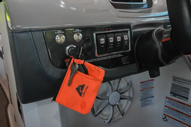 Slide: The Image of Control panel of a 2019 Chaparral Vortex 2430 VRX boat with keys and switches. - 38