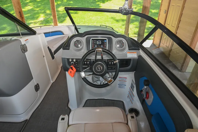 Slide: The Image of 2019 Chaparral Vortex 2430 VRX boat cockpit with steering wheel and dashboard controls. - 37