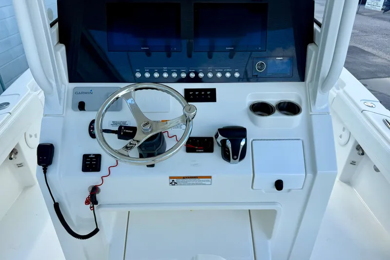 Slide: The Image of 2021 Regulator 26XO boat dashboard with Garmin displays and steering wheel. - 9