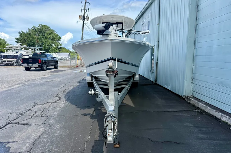 Slide: The Image of 2021 Regulator 26XO boat on trailer beside a building, ready for transport. - 3