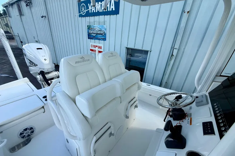 Slide: The Image of 2021 Regulator 26XO boat interior with dual seats and Yamaha engine. - 7
