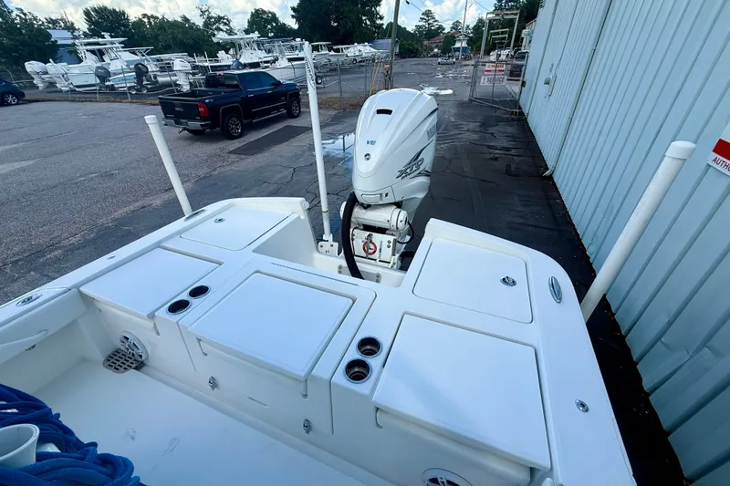 Slide: The Image of 2021 Regulator 26XO boat with Yamaha outboard motor, docked near a service area. - 10