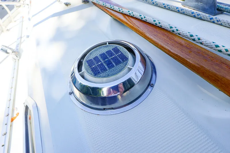 Slide: The Image of Solar vent on 1990 Ericson 32.5 sailboat deck with ropes and wood trim. - 14