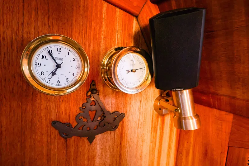 Slide: The Image of Brass clock and barometer on wooden panel of 1990 Ericson 32.5 sailboat interior. - 35