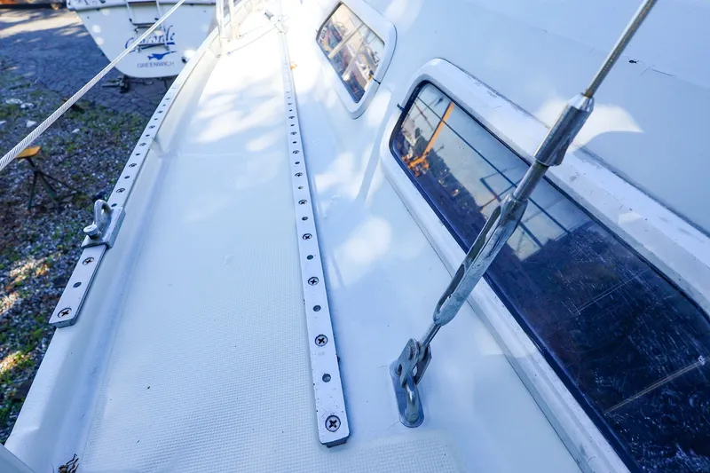 Slide: The Image of Deck view of a 1990 Ericson 32.5 sailboat, showcasing rigging and windows. - 15