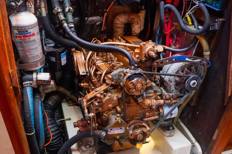 Slide: The Image of Engine compartment of a 1990 Ericson 32.5 sailboat, featuring mechanical components and wiring. - 40