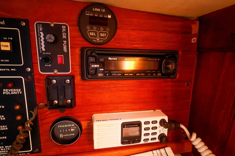 Slide: The Image of Control panel of a 1990 Ericson 32.5 sailboat with radio and bilge pump. - 32