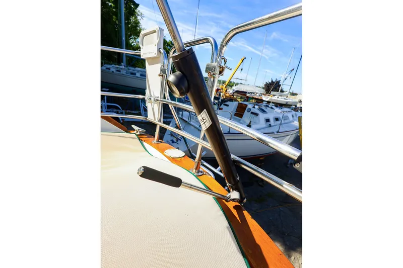 Slide: The Image of Close-up of a 1990 Ericson 32.5 sailboat deck with railing and winch handle. - 23