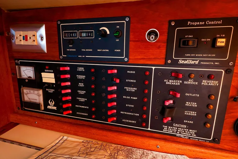 Slide: The Image of Control panel of a 1990 Ericson 32.5 sailboat, featuring electrical and propane systems. - 31