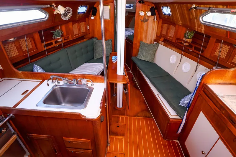 Slide: The Image of Cozy interior of a 1990 Ericson 32.5 sailboat with wooden finishes and seating. - 25