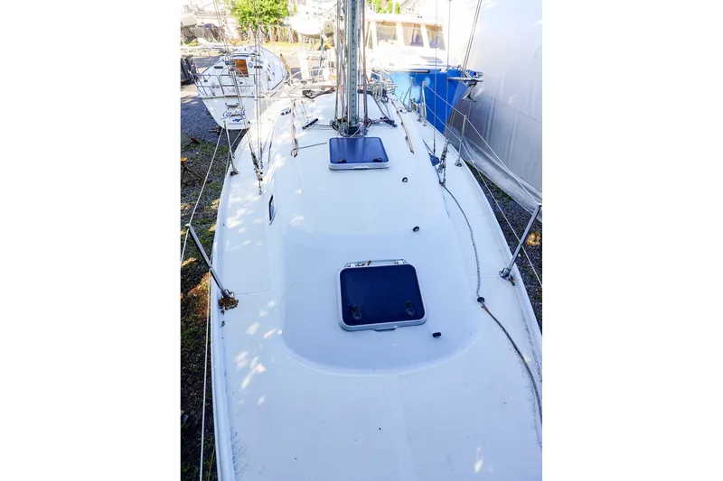 Slide: The Image of 1990 Ericson 32.5 sailboat deck view with hatches and rigging. - 20
