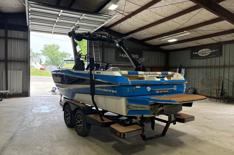 Slide: The Image of 2023 Malibu Wakesetter 21 LX boat in a garage, showcasing sleek design and vibrant colors. - 7