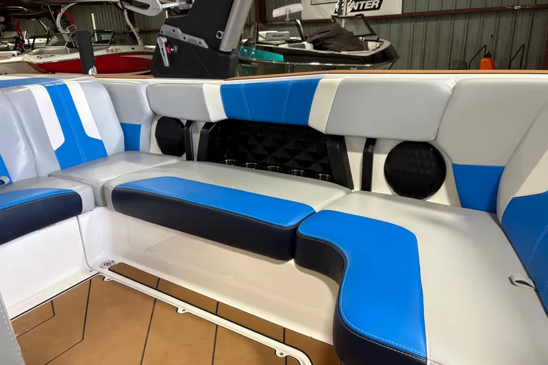 Slide: The Image of 2023 Malibu Wakesetter 21 LX interior with blue and white seating. - 3