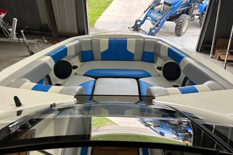 Slide: The Image of 2023 Malibu Wakesetter 21 LX boat interior with blue and gray seating. - 9