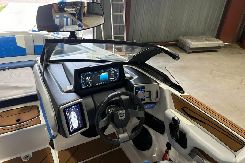 Slide: The Image of 2023 Malibu Wakesetter 21 LX boat dashboard with modern controls and sleek design. - 2