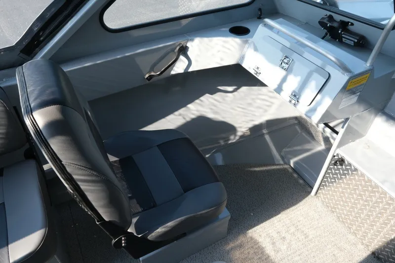 Slide: The Image of Interior of 2026 Hewescraft 180 Sportsman boat with seating and storage compartment. - 13