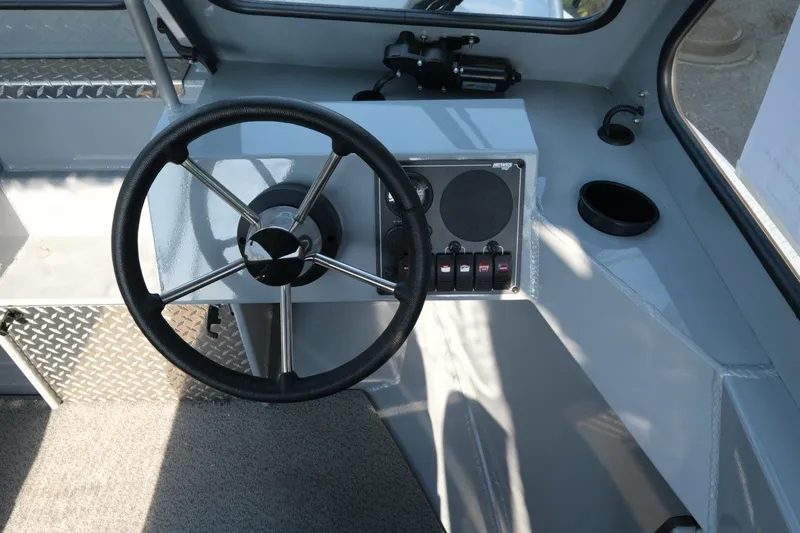 Slide: The Image of 2026 Hewescraft 180 Sportsman boat interior with steering wheel and control panel. - 12