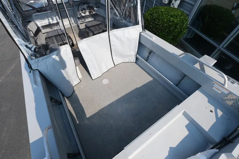 Slide: The Image of 2026 Hewescraft 180 Sportsman boat interior with spacious deck and protective canopy. - 8