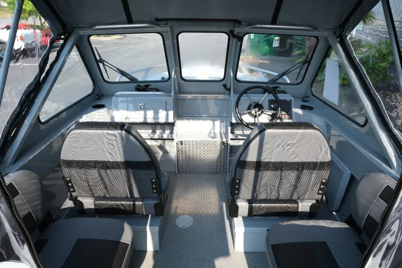 Slide: The Image of Interior of 2026 Hewescraft 180 Sportsman boat with seating and steering wheel. - 9
