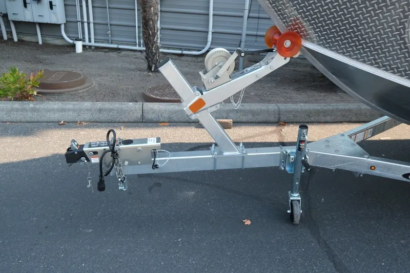 Slide: The Image of Trailer hitch of 2026 Hewescraft 180 Sportsman boat on pavement. - 15