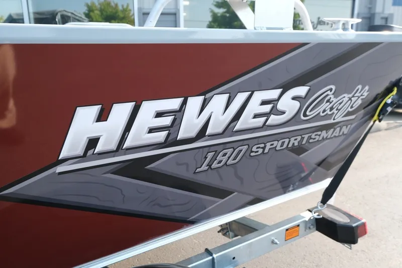 Slide: The Image of 2026 Hewescraft 180 Sportsman boat with bold branding on the side. - 7