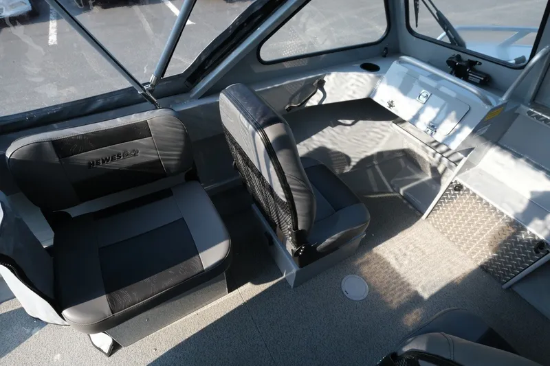 Slide: The Image of Interior of 2026 Hewescraft 180 Sportsman boat with seating and dashboard. - 10