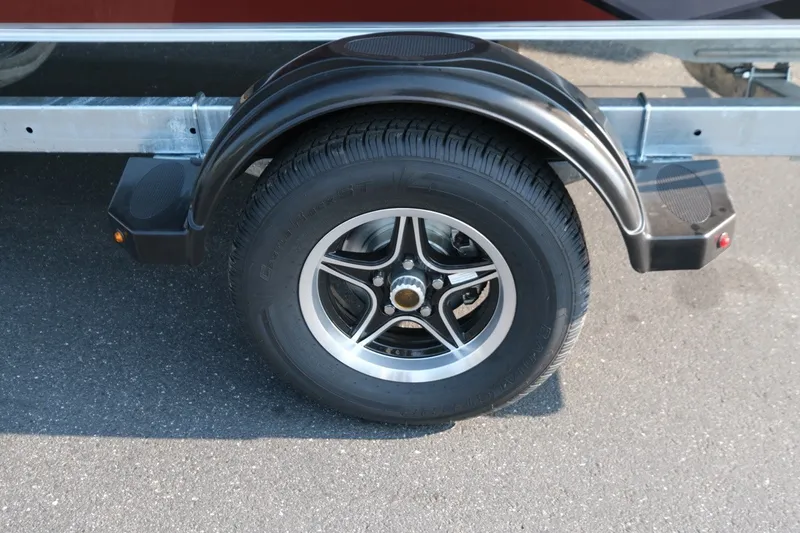 Slide: The Image of Trailer wheel of 2026 Hewescraft 180 Sportsman on asphalt surface. - 16