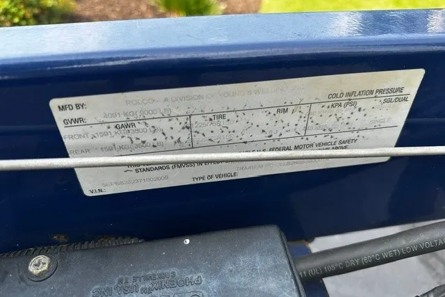 Slide: The Image of Label on a 2007 Crownline 260 LS boat, detailing weight and tire specifications. - 32