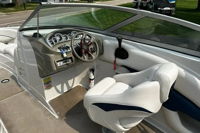 Slide: The Image of 2007 Crownline 260 LS boat interior with steering wheel and white seating. - 11