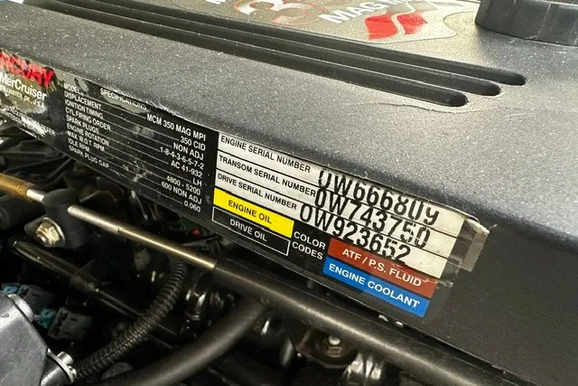Slide: The Image of Engine compartment of a 2007 Crownline 260 LS with serial numbers and fluid labels visible. - 28
